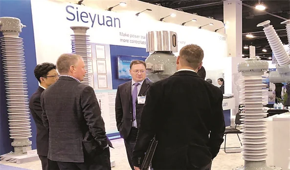 Des visiteurs &eacute;changent avec le personnel de Sieyuan sur son stand au salon IEEE PES T&D